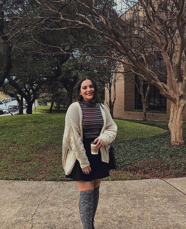 girl on school campus holding cup of coffee